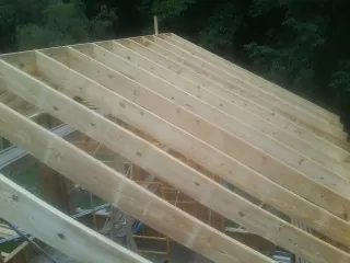 New roof rafters set over an addition before sheathing in Rosemount