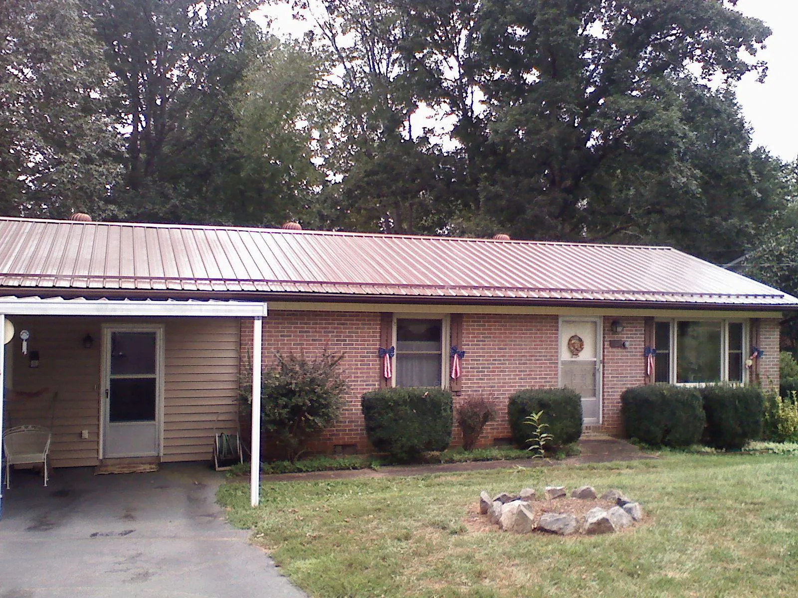 Bronze metal roof and carport on a brick ranch home — Roof Repair work by our crew in Rosemount